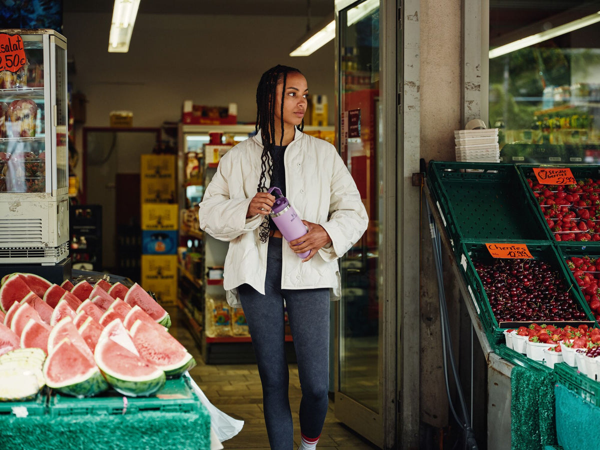 Woman At A Market Holding A Stanley IceFlow Tumbler